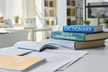 Close-up of textbooks for studying foreign language lying on table in classroom