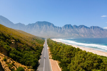 Kogelbay Beach Western Cape South Africa, Kogelbay Rugged Coast Line with spectacular mountain road. Garden route.couple man and women walking on the road, drone view