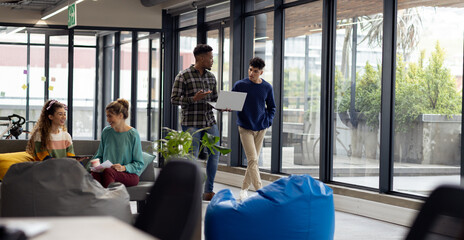 Busy diverse business people with laptop discussing work in office, unaltered
