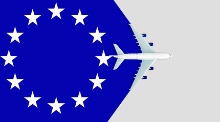 EU flag and the plane. The concept of travel. Toy airplane on the flag of the European Union