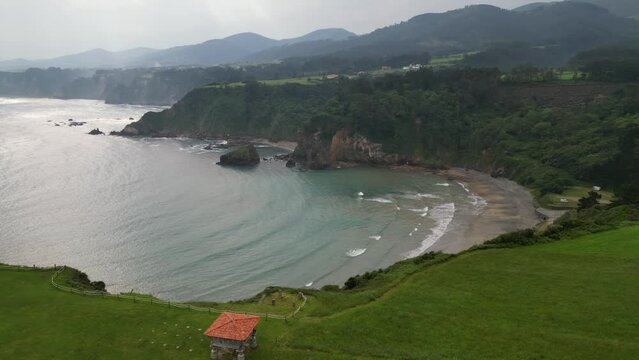 Flying over Cadavedo beach on the Asturian coast on a cloudy day.