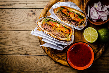 Hamburger or sandwich, beef torta with salsa dip and guacamole. Mexican cuisine.