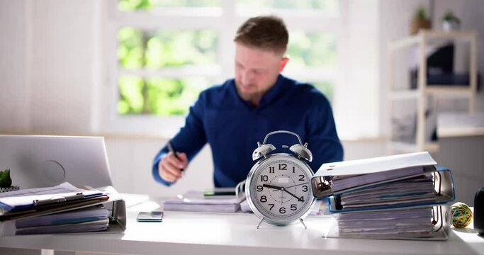 Accountant Calculating Bill With Time Clock