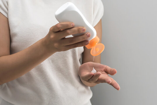 Woman applying moisure white cream lotion on hand, Hand Care concept