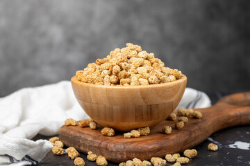 Dried mulberry. Sun-dried dried mulberry in wooden bowl. superfood Vegetarian food concept. healthy snacks.