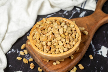 Dried mulberry. Sun-dried dried mulberry in wooden bowl. superfood Vegetarian food concept. healthy snacks.