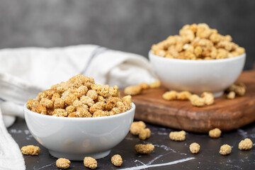 Dried mulberry. Sun-dried dried mulberry in ceramic bowl. superfood Vegetarian food concept. healthy snacks. Close up