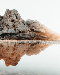 Mountain rock and water reflection - 605160620