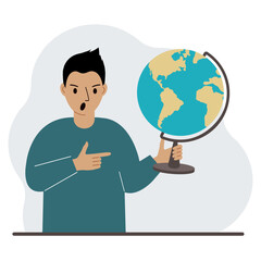 A man holds a globe in his hand and points his finger at it. The concept of education, teacher, world conquest, ecology.