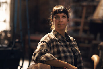 Woman blacksmith, portrait and workshop for industry, trade or artisan job for entrepreneurship. Small business owner, female entrepreneur or confident in factory, industrial warehouse or metalwork