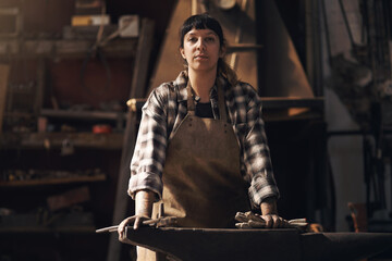Foundry, workshop and portrait of woman with tools for industry, manufacturing and manual labor. Industrial factory, welding and female person for steel, iron and metal production for craftsmanship