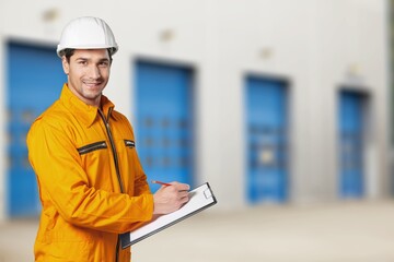 Portrait of smart engineer wearing safety helmet use clipboard
