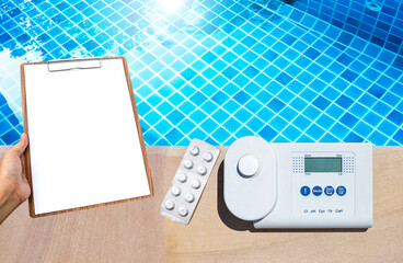 Digital swimming pool water tester with blank clipboard in girl hand over clear pool water background, swimming pool service and maintenance, report and check list, quality tester equipment