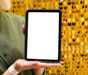 Mockup image of a woman holding and using digital tablet with blank white desktop screen over gold background