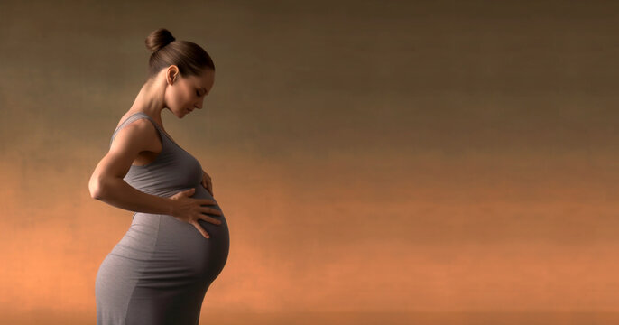 Pregnant woman in dress holds hands on belly on a dark background. Pregnancy, maternity, preparation and expectation concept. Close-up, copy space, indoors. Beautiful tender mood photo of pregnancy.