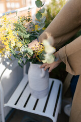 Young woman making bouquet of flowers