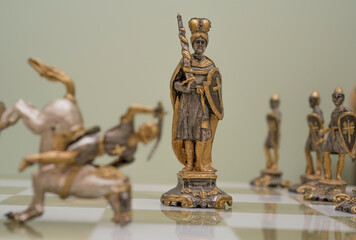 statuette of a person, chess on the board. 