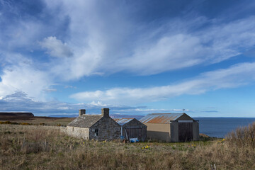 Fototapeta na wymiar Stone shed. Barn. Dunnet Head. Scotland. North coast. Brough. Orkney Islands in the back..