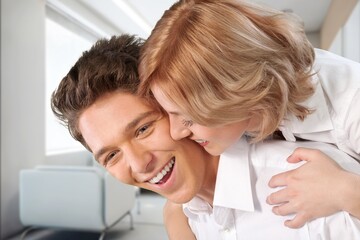 A happy young couple have fun in the living room.