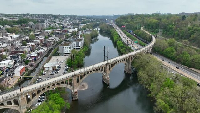 Aerial orbit around Manayunk bridge for pedestrians. USA small town outside of large city, Philadelphia.