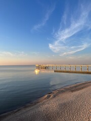 Fototapeta premium Old big pier at the sea, sunset seascape sky 