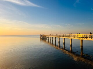 Old big pier at the sea, sunset seascape sky 