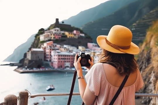 back view of Female tourist making a photo of Vernazza