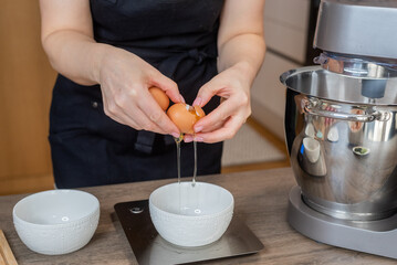 Fototapeta na wymiar person preparing a meal, woman breaks eggs 