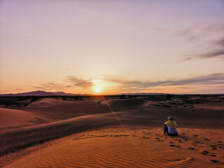Fototapeta na wymiar person on the gobi dessert watching sunset in mongolia