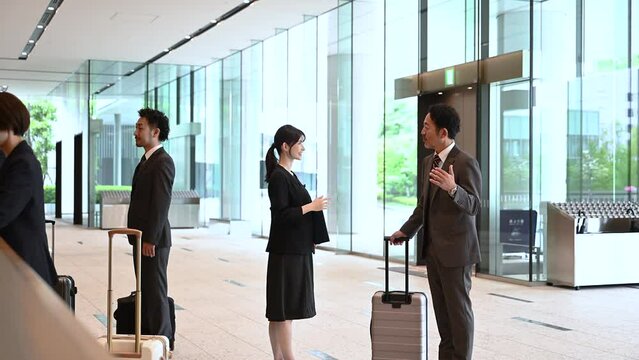 Women in the hospitality industry and businessmen Video of business and travel business trip scenes guided by hotel receptionists and concierges.