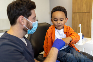 Cute little boy feeling relaxed after talk with his dentist