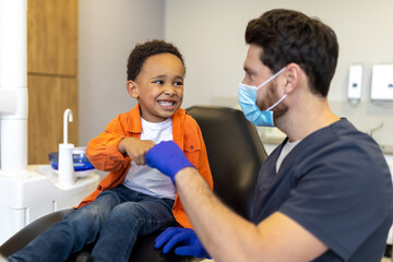 Cute little boy feeling relaxed after talk with his dentist