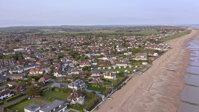 Aerial footage approaching East Preston and Angmering by Sea in West Sussex on the coast of Southern England.