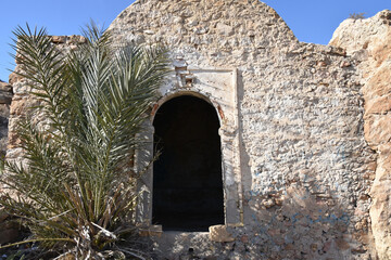 Rough Stone Facade and Doorway with Palm Tree, Takrouna, Tunsia