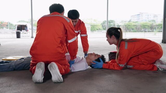Group of Asian emergency medical technician (EMT) or paramedic team is holding manual stabilization of the head patients and wearing neck collar, Emergency medical services (EMS) nurses concept