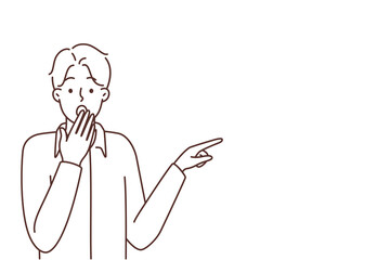 Stunned man point at blank copy space 