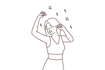 Smiling girl dancing to music 