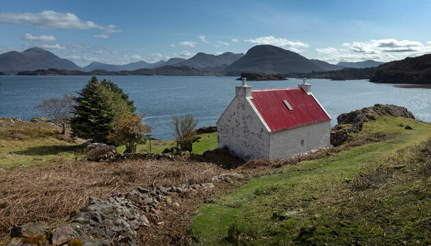 Loch Claira Scottish Highlands. Scotland. Lake.  Little white cottage with red roof. Mountains