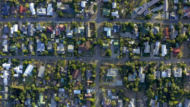 Property, neighborhood and overhead for home, house or apartment living in a small town residential area. Real estate, roof and buildings with urbaninzation development alongside the street or road