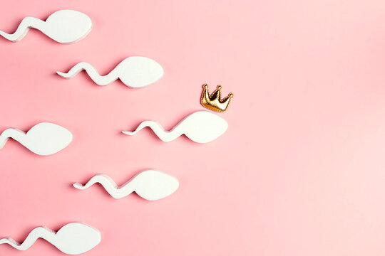 Spermatozoon in a crown on a pink background.