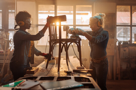 Carpenters sanding furniture.