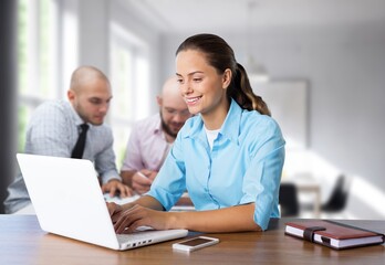 Fototapeta premium Positive young woman working on computer