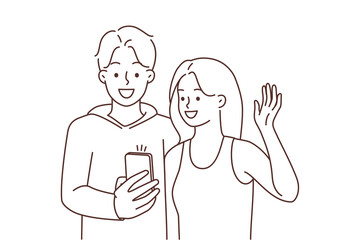 Smiling couple talking on video call on cell