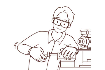 Male employee work on machine in workshop 