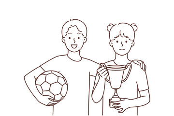 Smiling children with ball and golden prize 