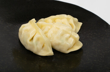 Gyoza Chinese Dumplings on Black Plate Closeup, Vegetable Jiaozi, Macro Chicken Momo Pile, Asian Gyoza