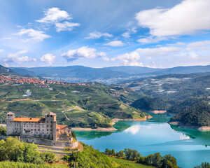Fabulous  View of the Cles Castel, the Santa Giustina Lake and lots of apple plantations. - obrazy, fototapety, plakaty
