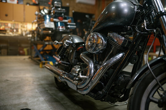 Shiny custom motorcycle after repair and restoration in workshop - Powered by Adobe