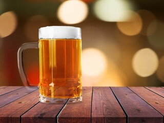A glass of cold beer on table in bar background.