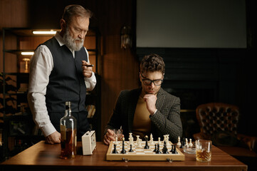 Two chess players taking break for smoking cigars